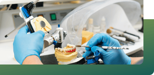Dental technician crafting custom dentures and dental crowns in a lab using precision tools and premium materials for optimal fit, aesthetics, and function.