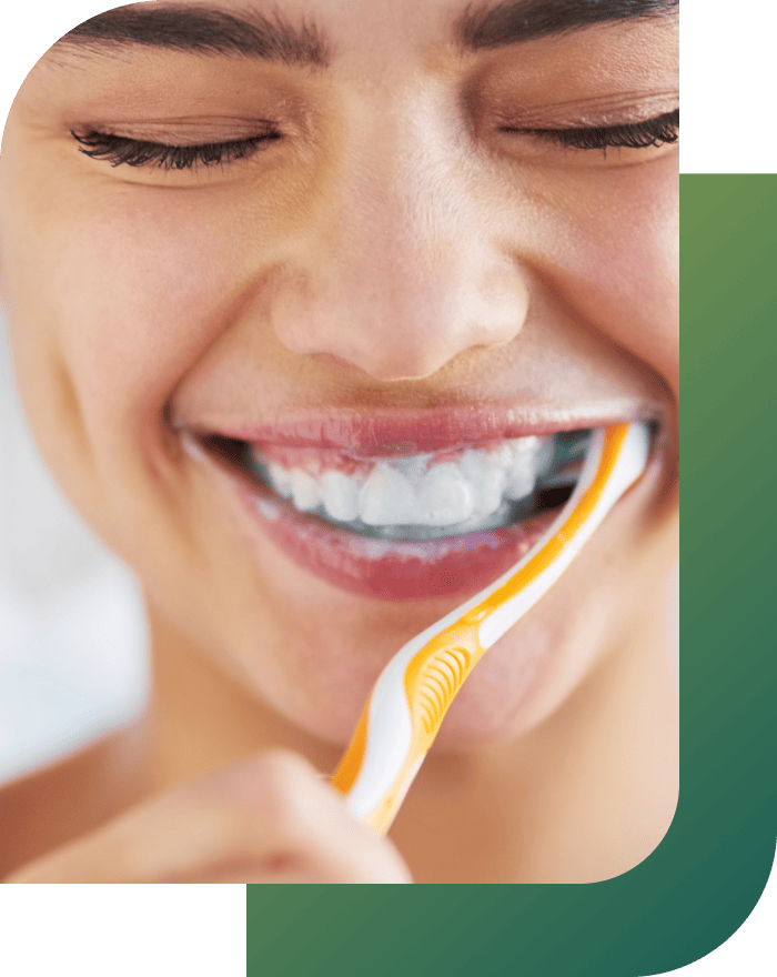 Girl brushing teeth, showing care for porcelain veneers.