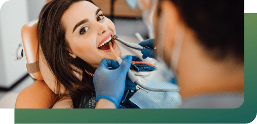 A dentist performing cosmetic dentistry on a patient at Woden Dental Centre.