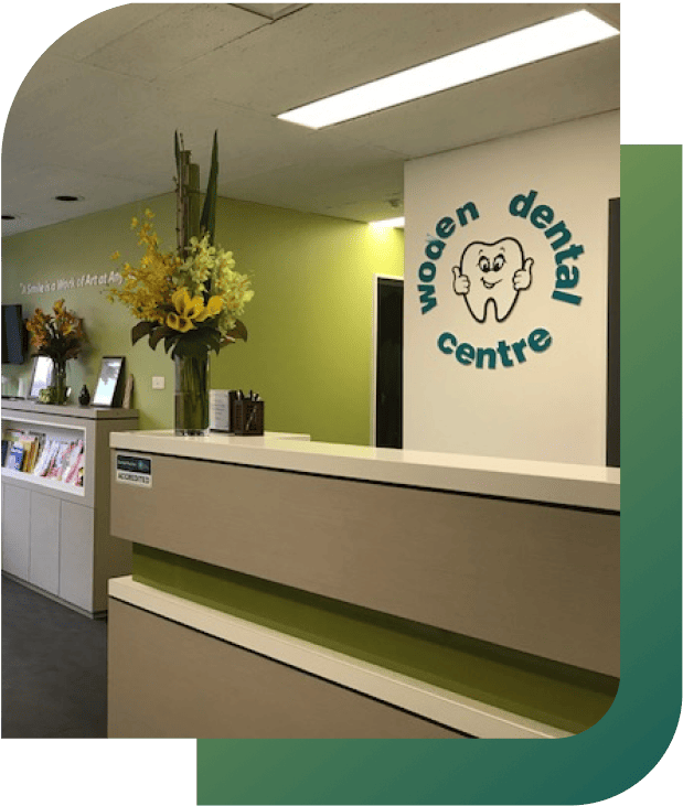 Front desk of Woden Dental Centre, featuring a reception area and signage.