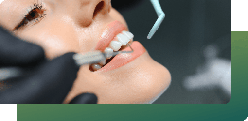 A patient having her teeth examined by a dentist using dental tools.