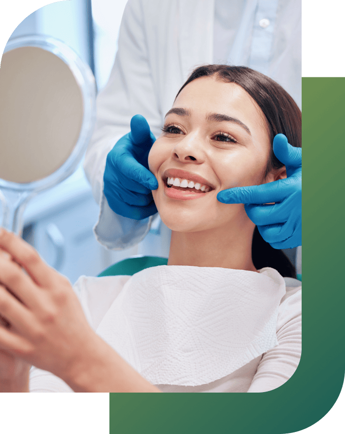 A patient viewing her teeth in the mirror post-treatment, showcasing the results of teeth whitening.