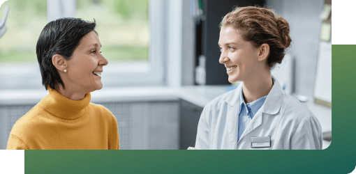 Patient in discussion with a dental expert in a clinic setting.