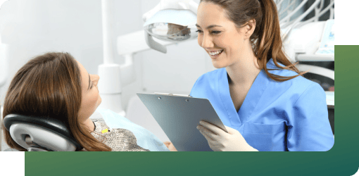 Dentist taking patient history for tooth abscess treatment, assessing symptoms.