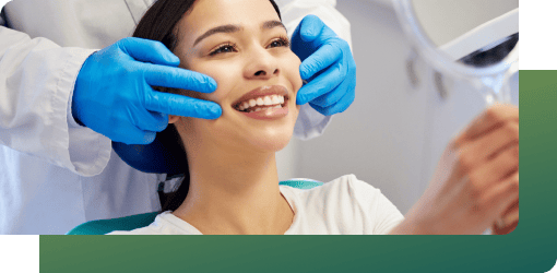 A dentist examines a patient's teeth and gums, offering care tips for dental bridges and scheduling regular check-ups.