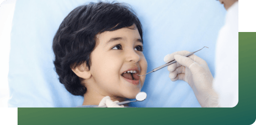 A dentist at a pediatric clinic checks a child's teeth to ensure healthy growth before new teeth appear.