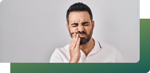 A man with severe tooth pain looking for urgent dental care, medicine, and treatment to relieve discomfort.