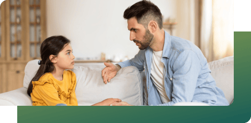 A father gets his child prepared for a dental checkup.