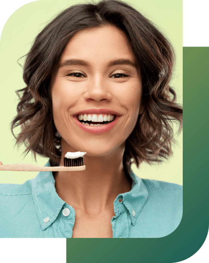 Young woman demonstrating the proper way to brush her teeth.