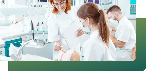 Dental staff receive hands-on training in dental infection control under an instructor’s supervision in a clinical setting.