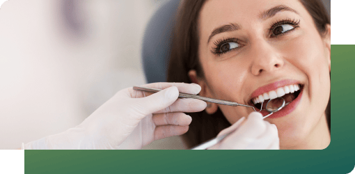 Dentist examining a patient's teeth to assess their dental care and health.