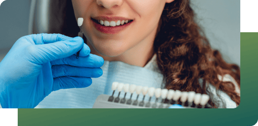 A dentist explains tooth-colored fillings to a patient, improving smile aesthetics in general dental services.