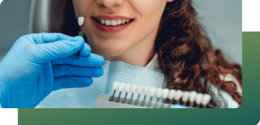 A dentist explains tooth-colored fillings to a patient, improving smile aesthetics in general dental services.