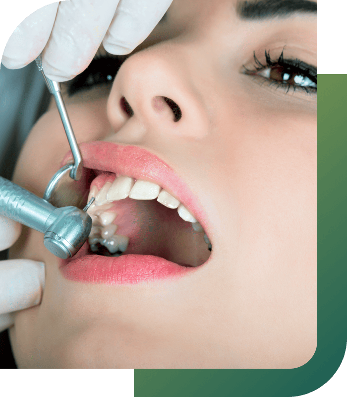 A dentist extracting a tooth from a patient using dental instruments.