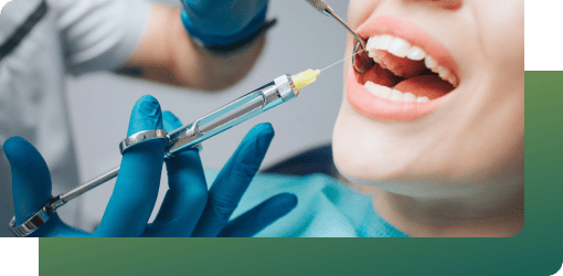 Dentist injecting local anesthesia to a patient's gum for the infected tooth treatment procedure.
