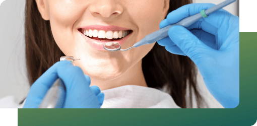A dentist using a dental mirror to inspect a patient's teeth and discussing treatment options, benefits, outcomes, and a full smile makeover.