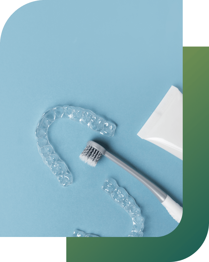 Clear aligners with cleaning tools showing proper care and hygiene for retainers.
