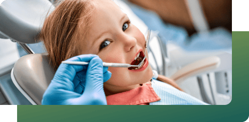 Dentist checking child’s mouth to assess damage from nail-biting habit.