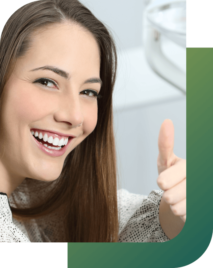 A happy patient giving a thumbs up after completing orthodontic treatment.
